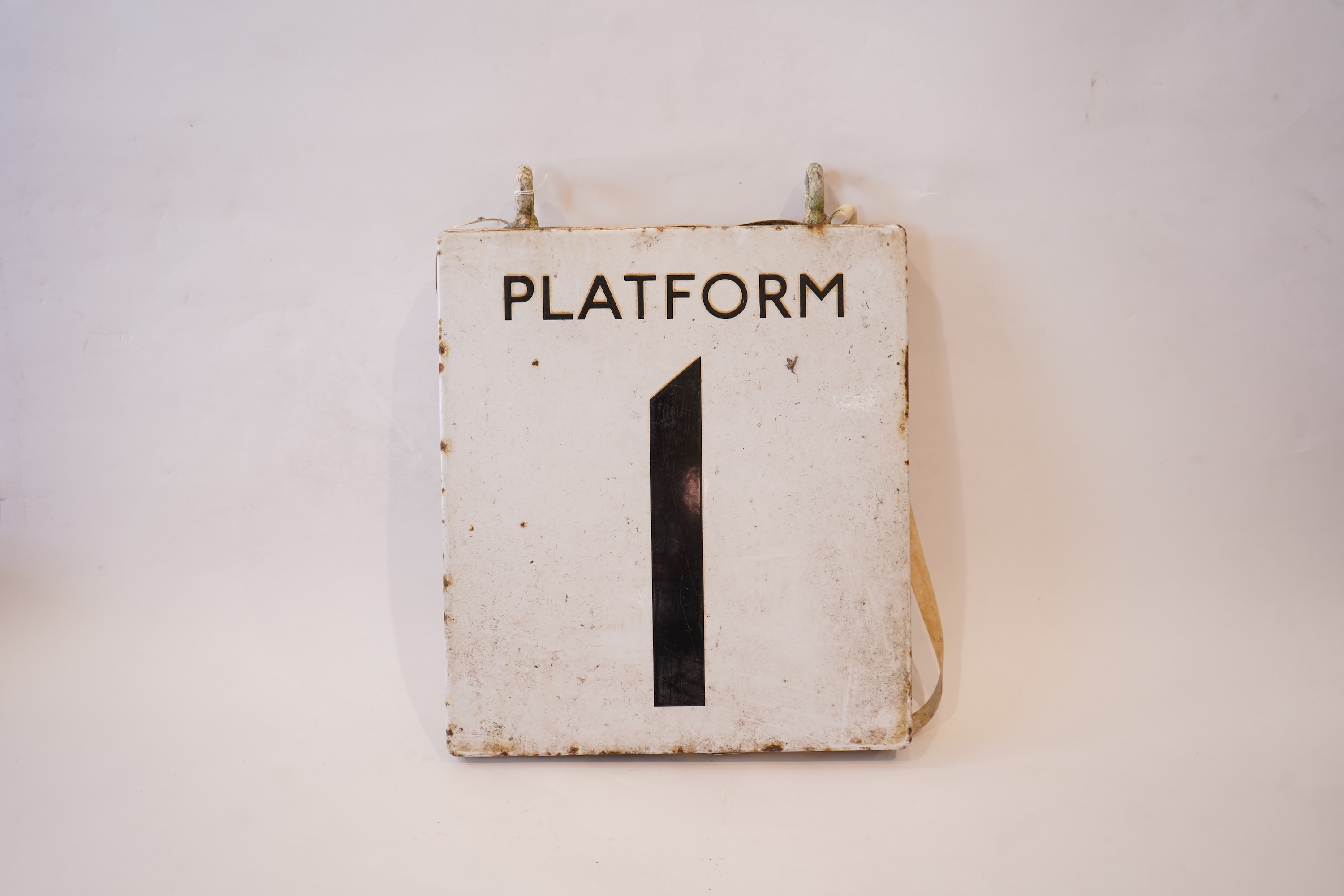 A 1960s London Underground double sided enamel platform sign 'Platform 1', with black lettering on white background, 46cm high, 41cm wide